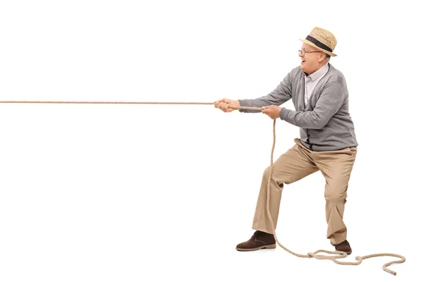 Cheerful senior pulling a rope — Stock Photo, Image