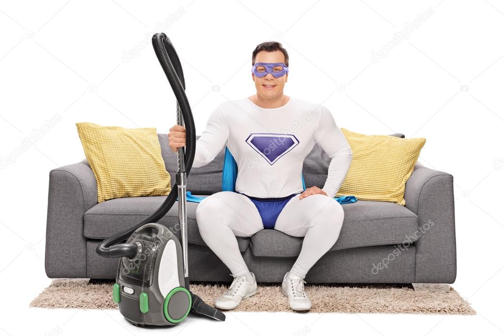 Joyful superhero with vacuum cleaner