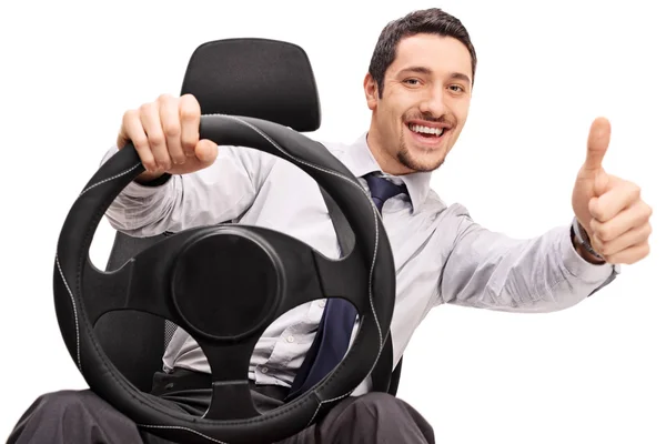 Young guy driving and giving a thumb up — Stock Photo, Image