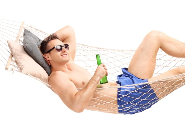 Handsome guy lying in a hammock — Stock Photo, Image