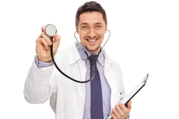 Young doctor holding a clipboard and a stethoscope — Stock Photo, Image