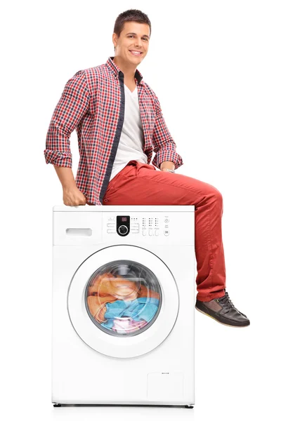 Young man waiting for the laundry — Stock Photo, Image