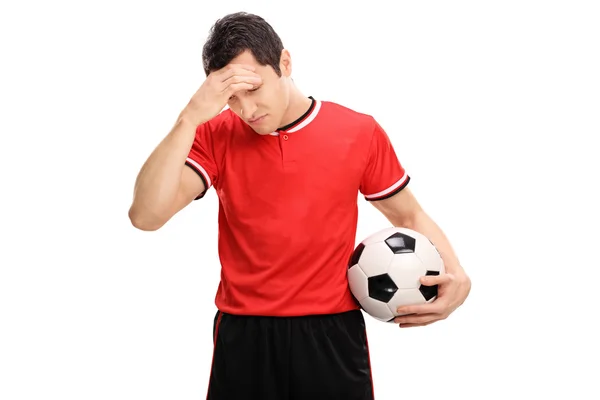 Sad football player looking down — Stock Photo, Image