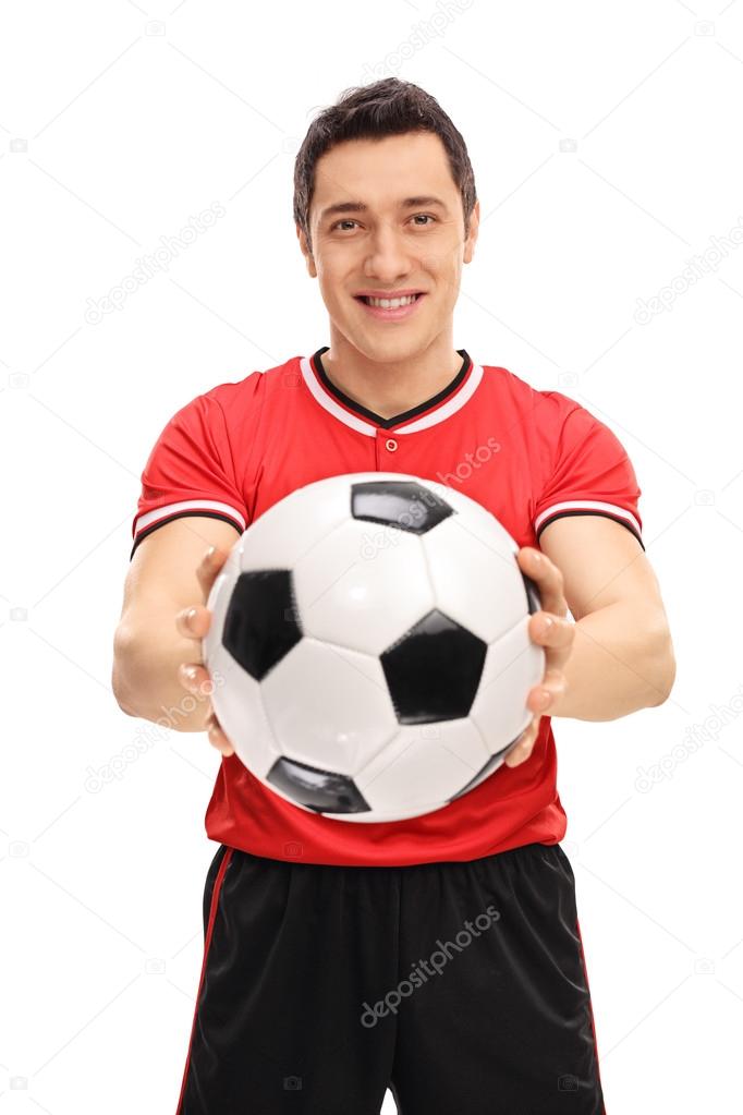 Young football player holding a ball 