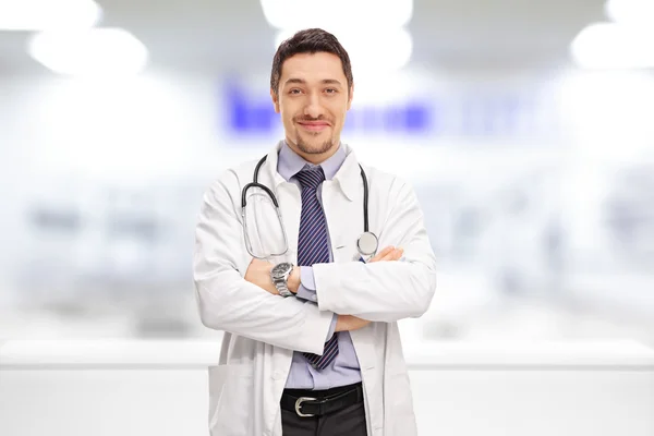 Cheerful doctor standing in a hospital room — Stock Photo, Image