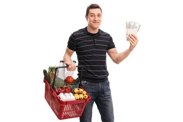 Homem económico compras e segurando dinheiro — Fotografia de Stock