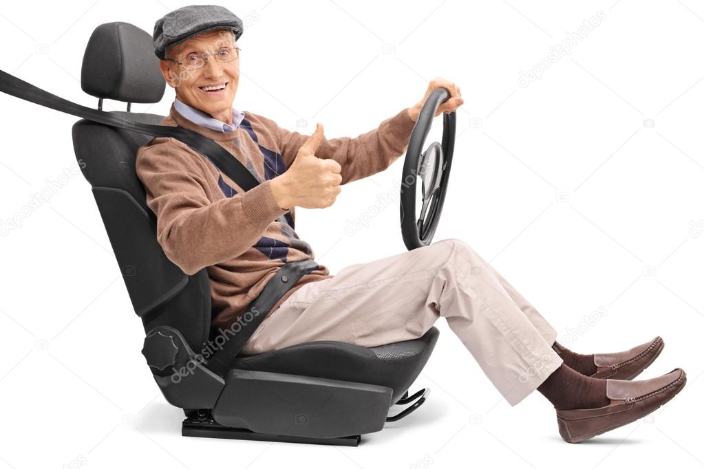 Senior man driving and giving a thumb up