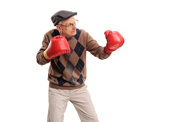 Starší muž s červeným Boxerské rukavice — Stock fotografie