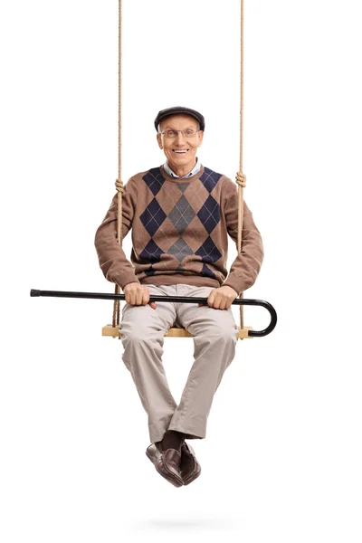 Senior man with cane and sitting on a swing — Stock Photo, Image