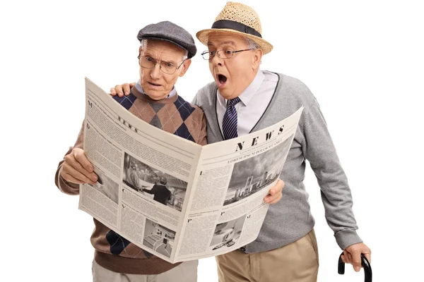 Baffled senior men reading newspaper — Stock Photo, Image
