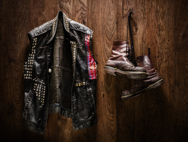 Punk jacket and boots hanging on a wall
