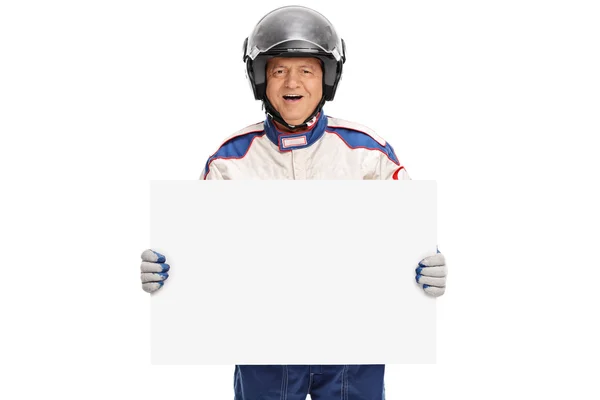 Mature car racer holding a signboard — Stock Photo, Image