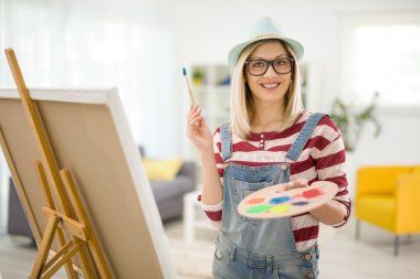 Evde poz neşeli kadın ressam 