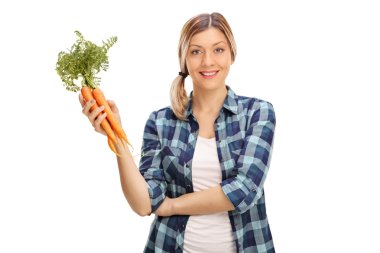 Birkaç havuç tutan genç kadın 