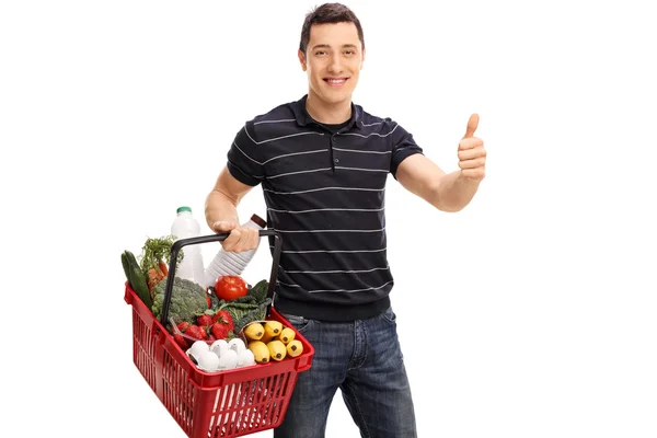 Guy carrying groceries and giving thumb up — Stock Photo, Image