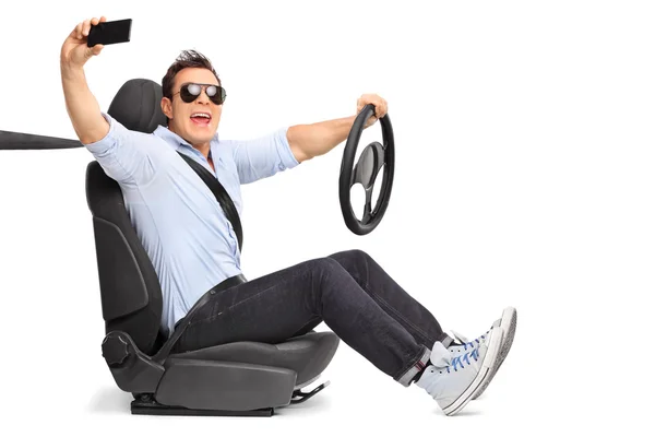 Young man driving and taking a selfie — Stock Photo, Image