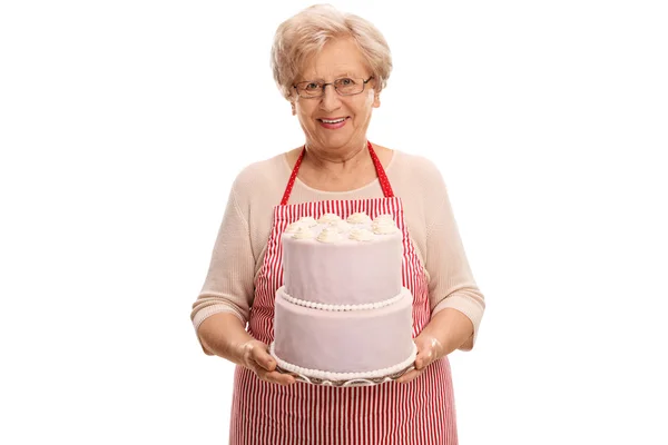 Mature lady holding a cake — Stock Photo, Image