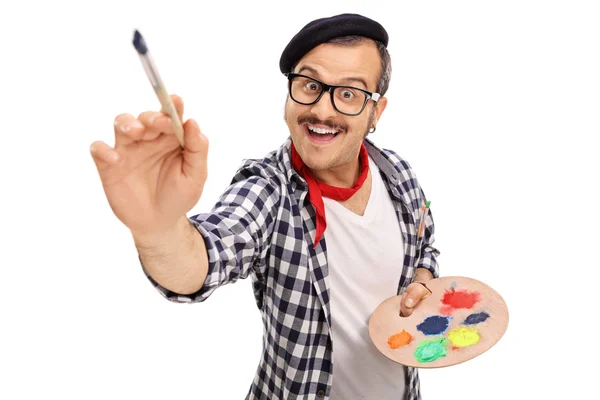 Joyful young artist painting with paintbrush — Stock Photo, Image