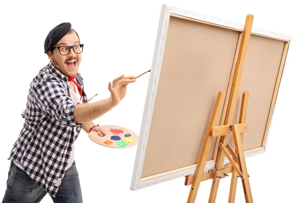 Excited artist painting on a canvas — Stock Photo, Image