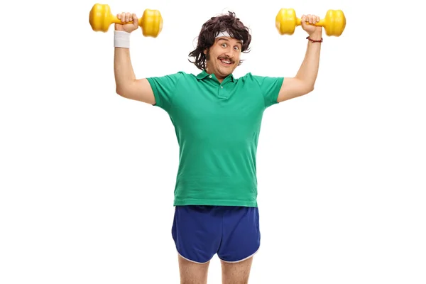 Retro young guy exercising with dumbbells — Stock Photo, Image