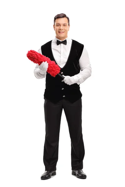 Cheerful butler holding a red duster — Stock Photo, Image