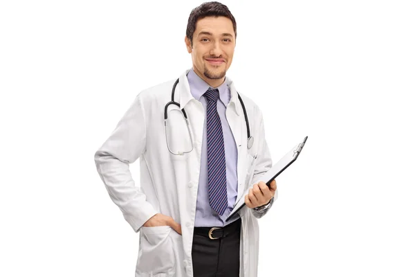 Young male doctor holding a clipboard — Stock Photo, Image