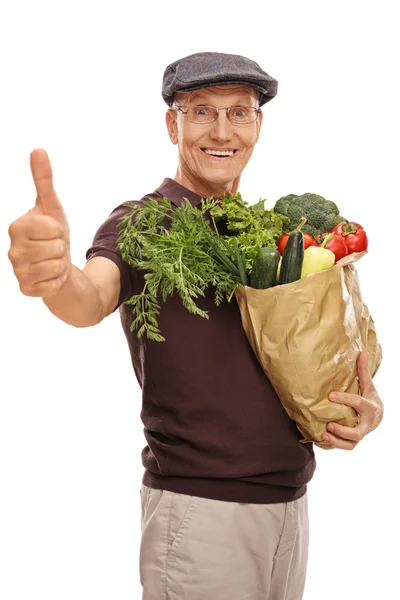 Senior man holding a grocery bag — Stock Photo, Image