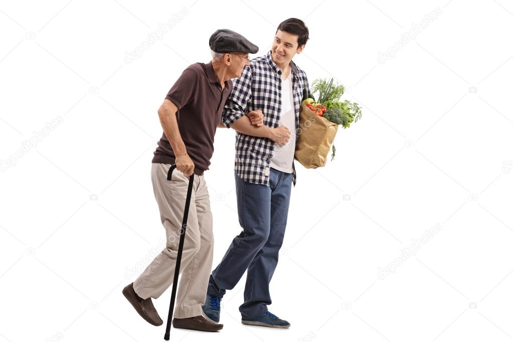 Kind man helping a senior gentleman with groceries Stock Photo by ...