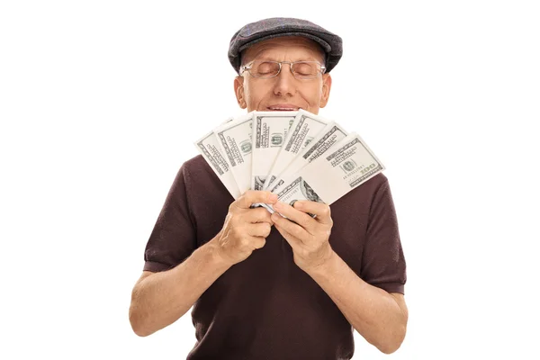 Senior gentleman smelling money — Stock Photo, Image