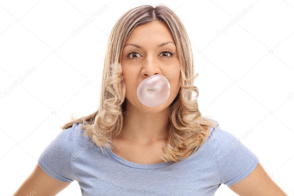 Woman blowing a bubble from a gum 