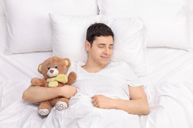Neşeli adam bir oyuncak ayı ile uyku
