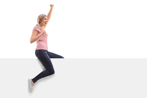 Overjoyed woman sitting on a panel — Stock Photo, Image