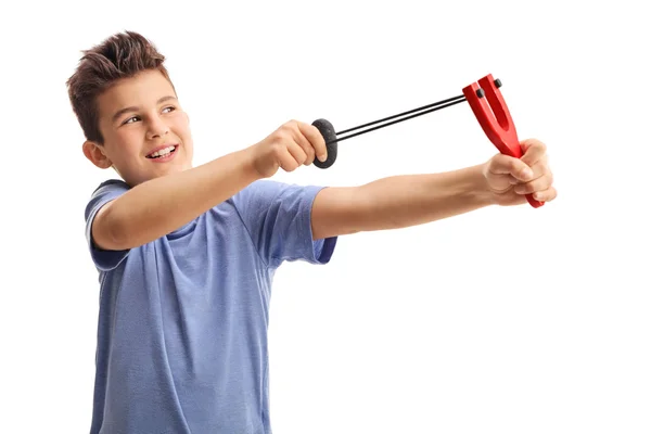 Cheerful kid shooting with a slingshot — Stock Photo, Image