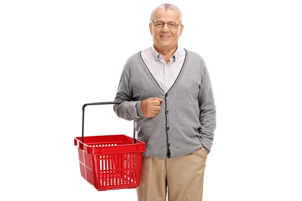 Mature man holding a shopping basket — Stock Photo, Image