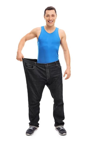 Killen i ett par stora jeans — Stockfoto