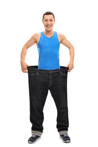 Man showing how much weight he lost — Stock Photo, Image