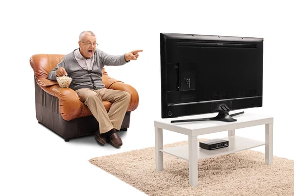 Happy mature man watching TV — Stock Photo, Image