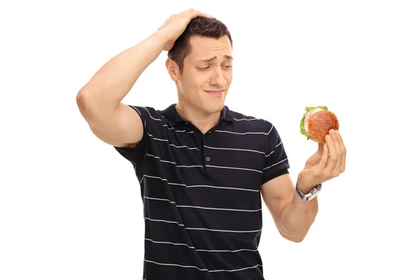 Tempted guy looking at a sandwich — Stock Photo, Image