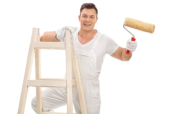 Young decorator holding a paint roller Royalty Free Stock Photos