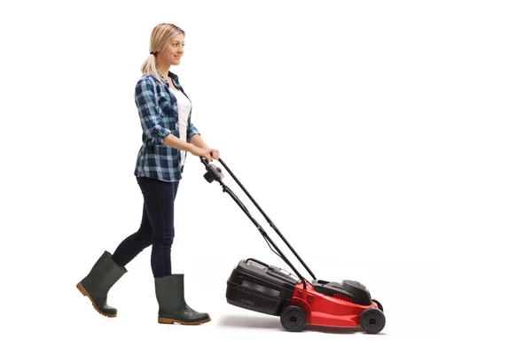 Young woman pushing a lawn mower — Stock Photo, Image