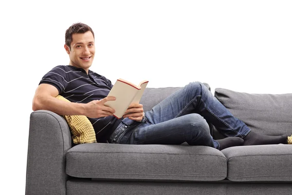 Cheerful guy holding a book — Stock Photo, Image