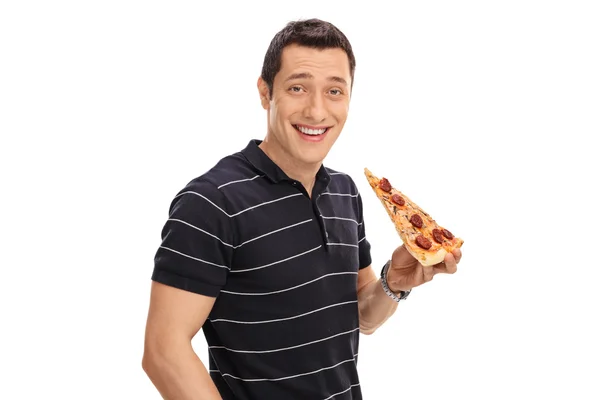 Man har en bit pizza — Stockfoto