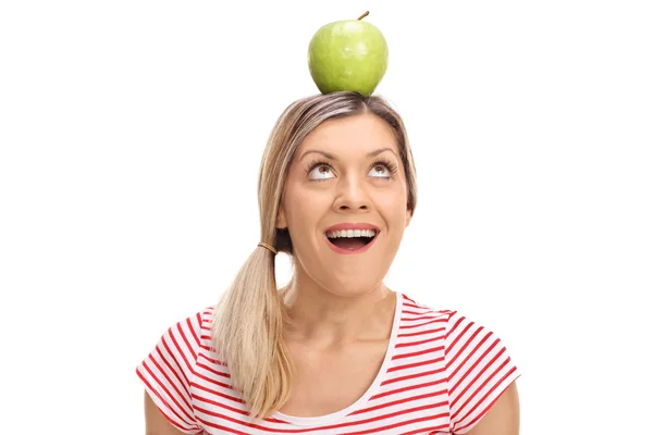 Blond woman balancing an apple — Stock Photo, Image