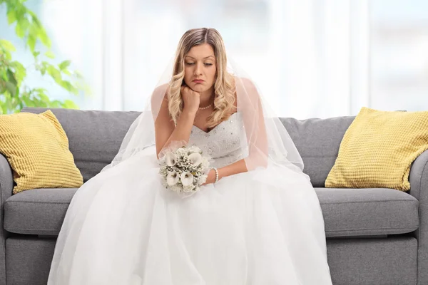 Depressed bride sitting on a sofa — Stock Photo, Image