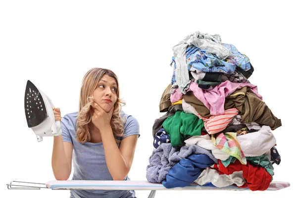 Woman looking at a pile of clothes — Stock Photo, Image