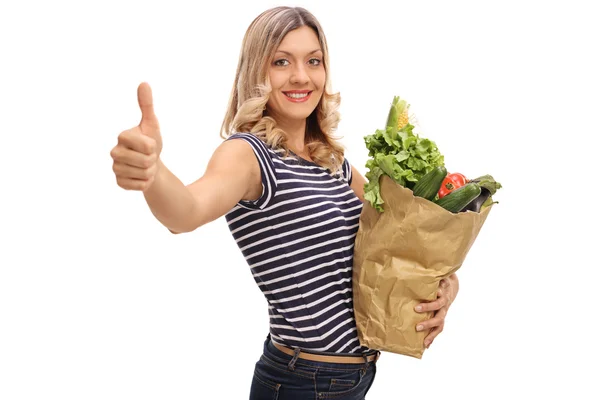 Woman holding a bag of groceries — Stock Photo, Image