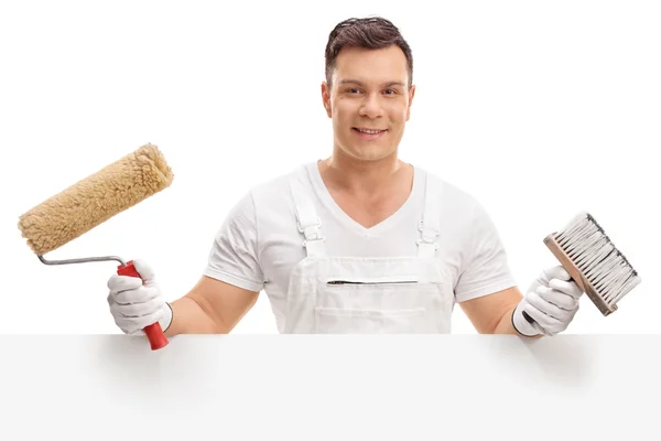 Painter posing behind a blank panel — Stock Photo, Image