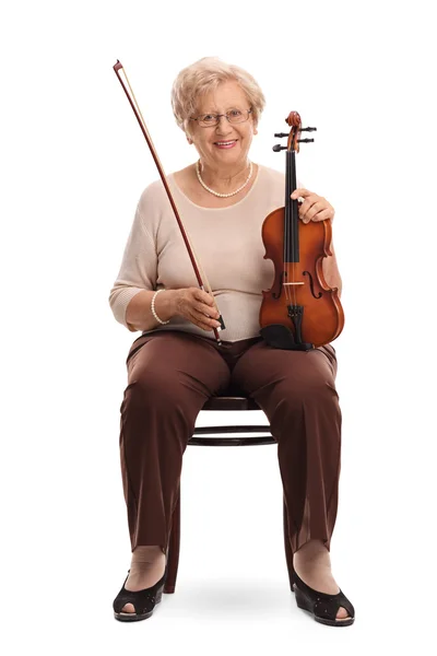 Mujer madura sosteniendo un violín y un arco — Foto de Stock