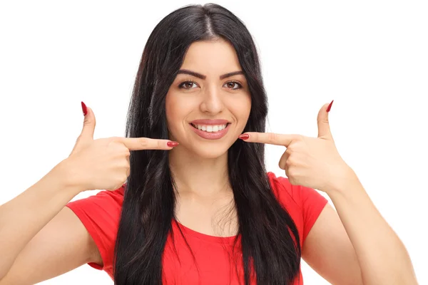Woman pointing at her mouth and smiling — Stock Photo, Image