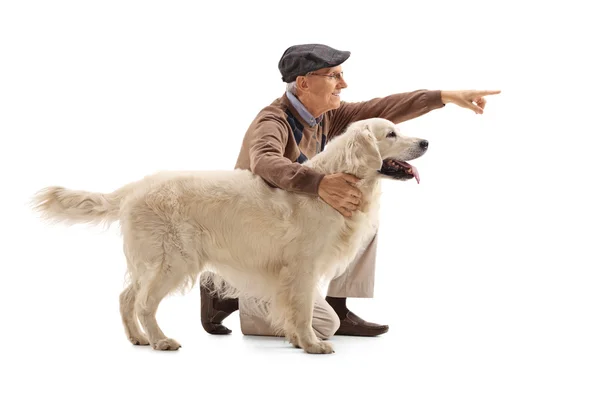 Elderly man showing something to his dog — Stock Photo, Image
